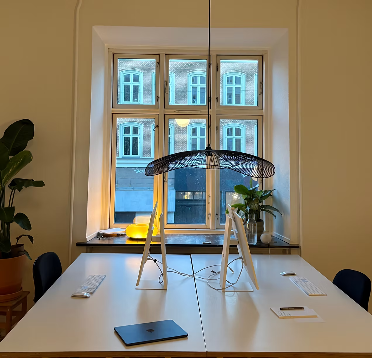 Hypedbyus-kontor med arbejdspladser ved vinduet